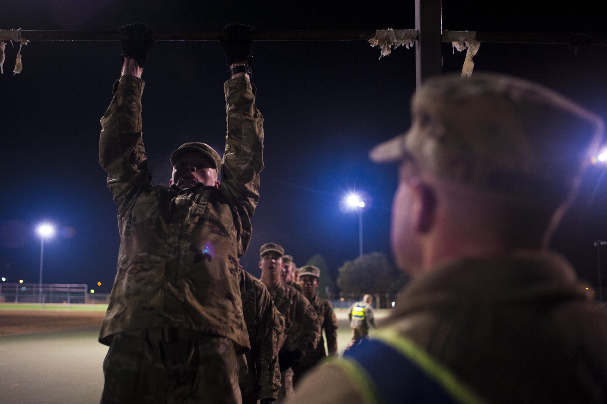 A soldier from the 344th Military Intelligence Battalion performs a pullup during the Spartan Race at the Mathis football field on Goodfellow Air Force Base, Texas, February 3, 2017. Alpha company won the competition. (U.S. Air Force photo by Senior Airman Scott Jackson/Released)