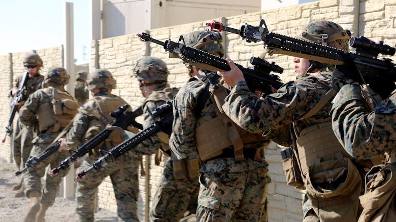 Marines stack and maneuver around a wall during Military Operations in Urban Terrain training aboard Marine Corps Outlying Field Atlantic, N.C., Feb. 2, 2017. Marines stack themselves one after another as a tactical advantage for breaching a doorway. Nearly 40 Marines with supporting personnel participated in the weeklong training that simulated hostile takeovers and how to overcome unexpected situations with small unit leadership. The Marines are assigned to Marine Wing Support Squadron 271, Marine Aircraft Group 14, 2nd Marine Aircraft Wing.