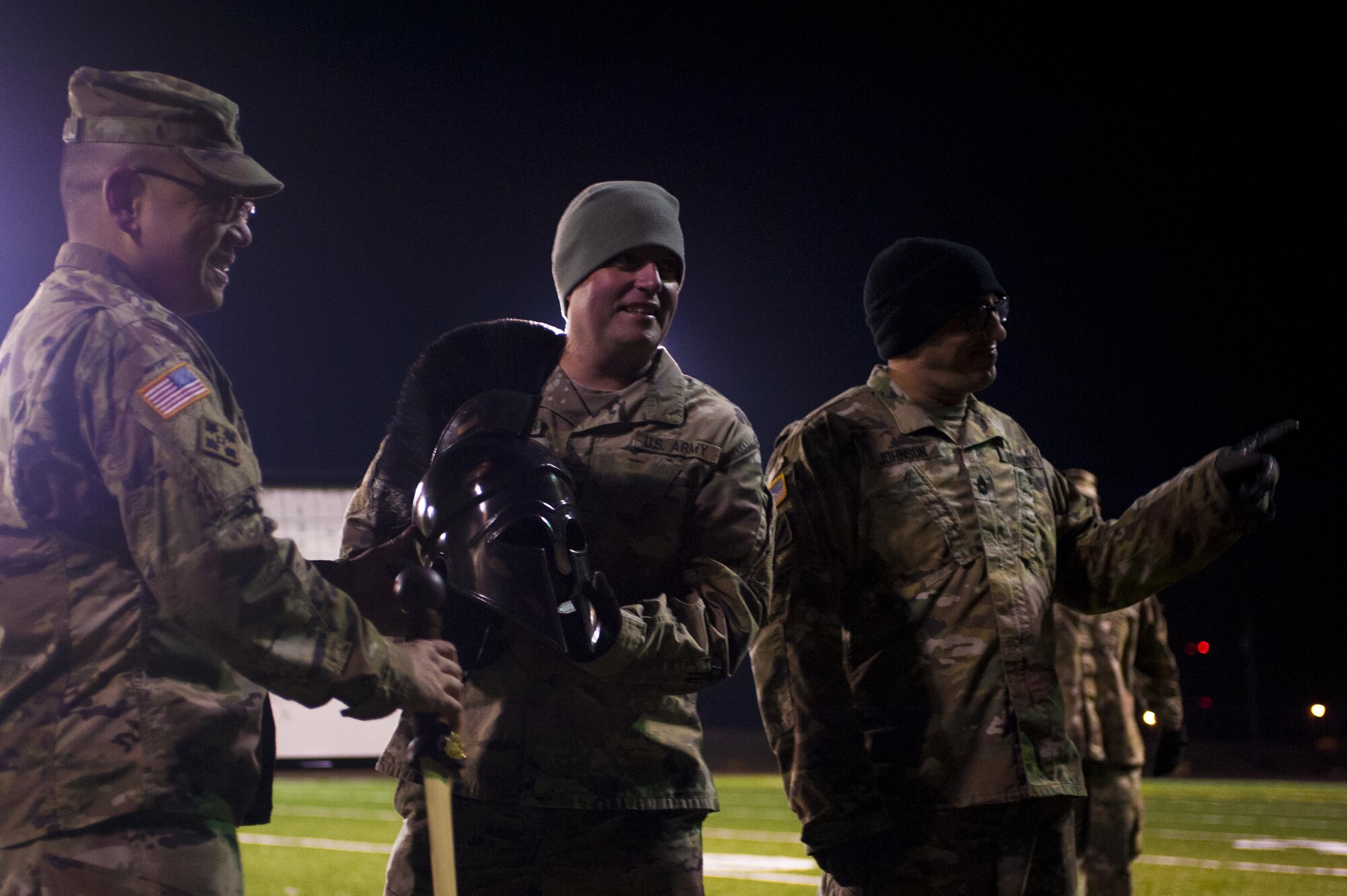 U.S. Army Lt. Col. Yukio Kuniyuki, 344th Military Intelligence Battalion Commander, presents the galea helmet and broadsword trophies to Capt. Matthew Bontrager, 344th MIB Alpha Company commander, and 1st Sgt. Joseph Johnson, 344th MIB Alpha Company first sergeant, at the Mathis football field on Goodfellow Air Force Base, Texas, February 3, 2017. This competition is held each year to help build comradery between soldiers. (U.S. Air Force photo by Senior Airman Scott Jackson/released)