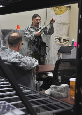 Staff Sgt. William Fortier, 931st Civil Engineer Squadron emergency manager, presents the sections of Mission Oriented Protective Posture gear during a Chemical, Biological, Radiological, Nuclear, and Explosives class Feb. 5, 2017, McConnell Air Force Base, Kan. Regular CBRNE training is required so Airmen stay familiar with life-saving equipment and procedures. (U.S. Air Force photo by Senior Airman Preston Webb)