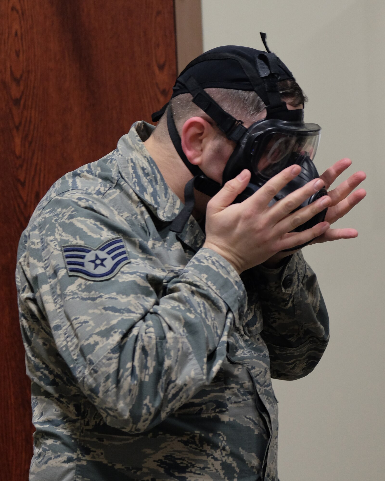 Staff Sgt. William Fortier, 931st Civil Engineer Squadron emergency manager, demonstrates how to properly check a gas mask’s seal gear during a Chemical, Biological, Radiological, Nuclear, and Explosives class Feb. 5, 2017, McConnell Air Force Base, Kan. Without a proper seal Airmen are left susceptible to dangerous gases.  (U.S. Air Force photo by Senior Airman Preston Webb)