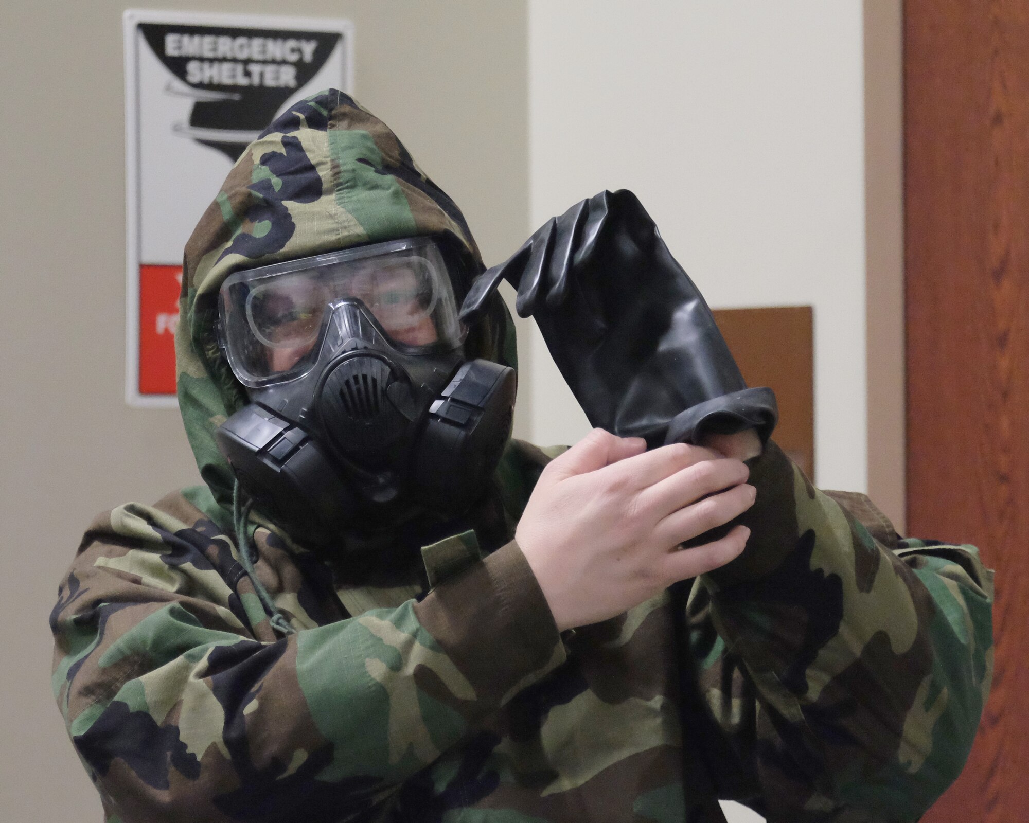 Staff Sgt. William Fortier, 931st Civil Engineer Squadron emergency manager, displays common errors while donning Mission Oriented Protective Posture gear during a Chemical, Biological, Radiological, Nuclear, and Explosives class Feb. 5, 2017, McConnell Air Force Base, Kan.  Regular CBRNE training is required so Airmen stay familiar with life-saving equipment and procedures. (U.S. Air Force photo by Senior Airman Preston Webb)