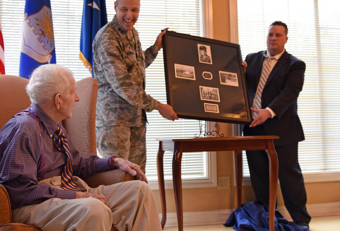 U.S. Air Force Maj. Gen. Thomas Bussiere, 8th Air Force commander, presents 93-year-old World War II veteran Raymond Odom with his dog tags at Arbor Rose Assisted Living Facility in Farmerville, La., Feb. 2, 2017. Odom was assigned to the 8th Air Force during WWII, and was presented his dog tags that were misplaced in 1945. The dog tags, found in England, made their way across the pond to Barksdale Air Force Base to be presented to Odom during an 8th Air Force 75th Anniversary official ceremony. (U.S. Air Force photo by Senior Airman Erin Trower)