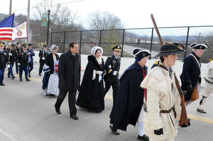 Brigadier General Stephen E. Strand, deputy commanding general for the 88th Regional Support Command, walks with President William Henry Harrison's wife Anna Symmes Harrison (played by Susan Bell, a direct descendent of Anna), toward the Harrison Tomb in North Bend, Ohio, Feb. 3, during the ceremony to honor the ninth President of the United States.