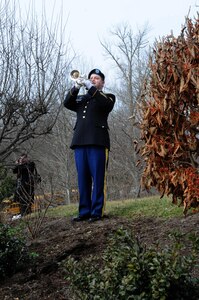 Sergeant Martin Maggart, 338th Army Band, plays Taps during the wreath laying ceremony honoring President William Henry Harrison in North Bend, Ohio, Feb. 3, 2017.