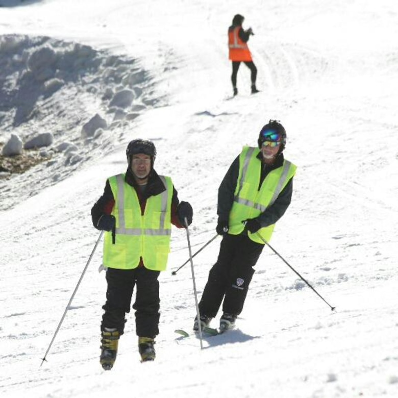 Marcus Brumbaugh, an electrical equipment mechanic at the Cordell Hull Dam in Carthage, Tenn., guides an adaptive skier during downhill at the 36th Disabled Sports USA Adaptive Learn to Ski event clinic at the Beech Mountain Resort in Beech Mountain, N.C., Jan. 19, 2017.     