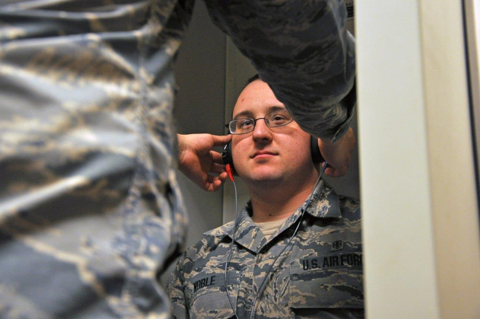 Senior Airman Logan Noble demonstrates getting fitted with audio phones for an audiogram during a Periodic Health Assessment. The Aerospace and Operational Medicine flight manages the PHA program for all active duty, guard and reserve personnel at Wright-Patterson AFB and geographically separated units. (U.S. Air Force photo/Myra Saxon)