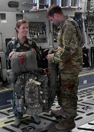 U.S. Army Capt. John Nance, 1st Battalion, 505th Parachute Infantry Regiment, 3rd Brigade Combat team, 82nd Airborne Division (1-505 PIR, 3 BCT 82 Abn. Div.) jumpmaster, right, attaches parachute harness with combat equipment  to U.S. Air Force Capt. Keely Yankie, 16 Airlift Squadron pilot, left, during a C-17 Globemaster III tour here, Feb. 3, 2017. During the visit Airmen from the 437th Airlift Wing discussed air drops, Army and Air Force capabilities, equipment characteristics and combat power with the 1-505 PIR, 3 BCT 82 Abn. Div. Soldiers. The tour provided the opportunity to develop more effective joint force airborne operations in the future. While in Charleston, the Soldiers also visited the USS Yorktown at Patriots Point to pay tribute to a Medal of Honor recipient, U.S. Army Sgt. 1st Class Felix Conde-Falcon, a paratrooper from the 1-505 PIR, 3 BCT 82 Abn. Div.