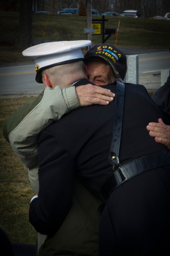 Newly-commissioned 2nd Lt. Charles Valenza, gratuate of University of New Hampshire, hugs his grandfather, a Korean War veteran, following his commissioning ceremony, Jan. 14, 2017. Valenza commissioned through the Platoon Leaders Course, where college students attend Officer Candidate School during their college summers and commisson upon graduation.