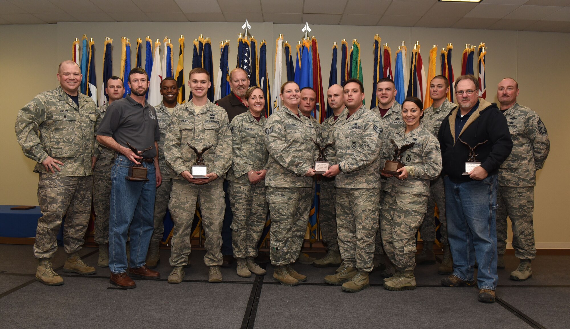 Col. Matthew Dillow, 90th Missile Wing vice commander, and Chief Master Sgt. Kristian Farve, 90th Operations Group superintendent, pose with the wing’s fourth quarter award winners at F.E. Warren Air Force Base, Wyo., Feb. 3, 2017. The wing held a celebration for all the nominees and presented the awards to the winners during a ceremony. (U.S. Air Force photo by Airman 1st Class Breanna Carter)