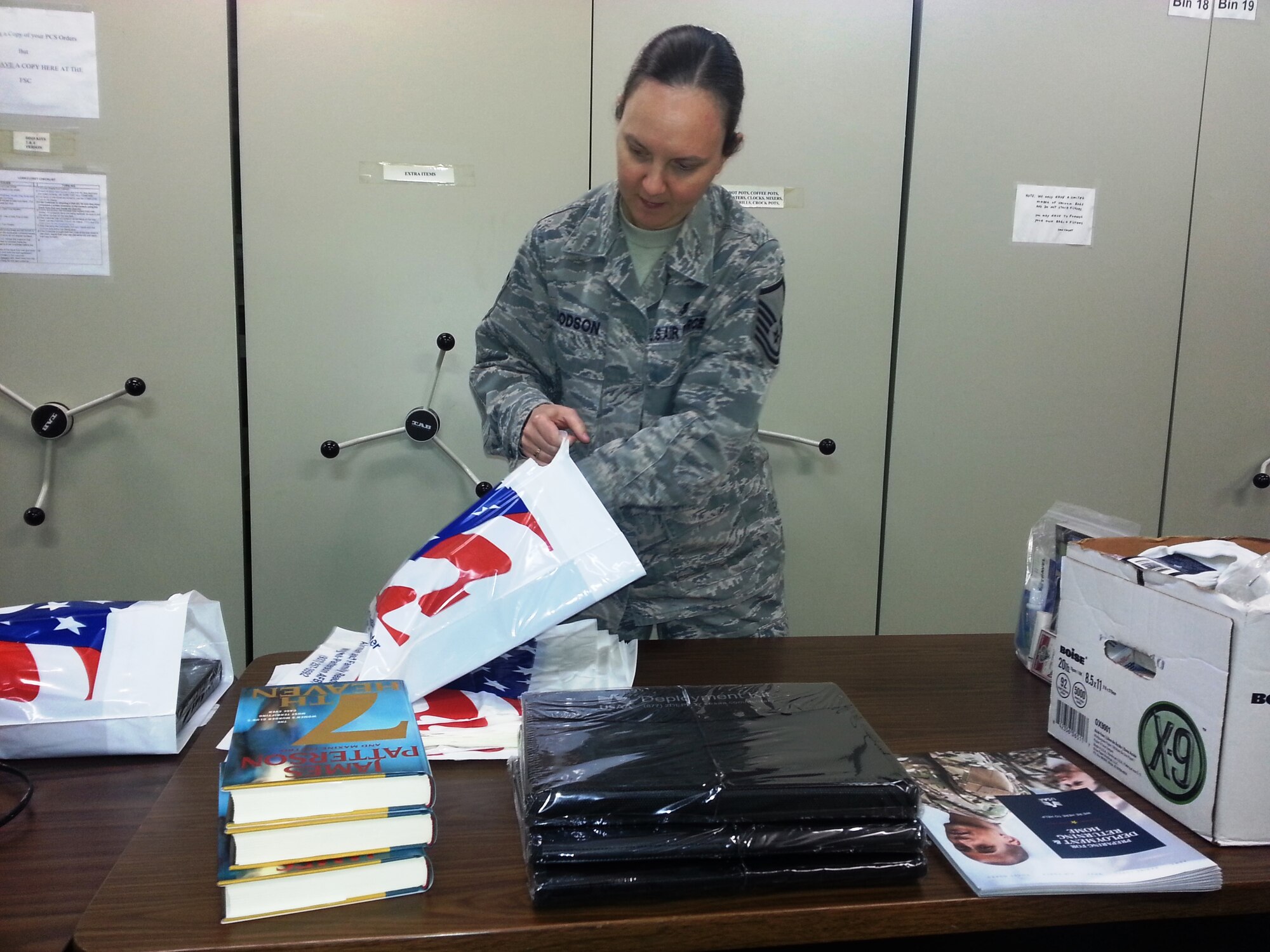 Master Sgt. Christina Dodson, Airman & Family Readiness Center, Readiness Senior Non-Commissioned Officer, prepares deployment care packets to pass out to families during a pre-deployment briefing. Service members are required to attend mandatory briefings prior to leaving to get information on all resources and services available to their families during their absence. (U.S. Air Force photo/Gary Sapp).