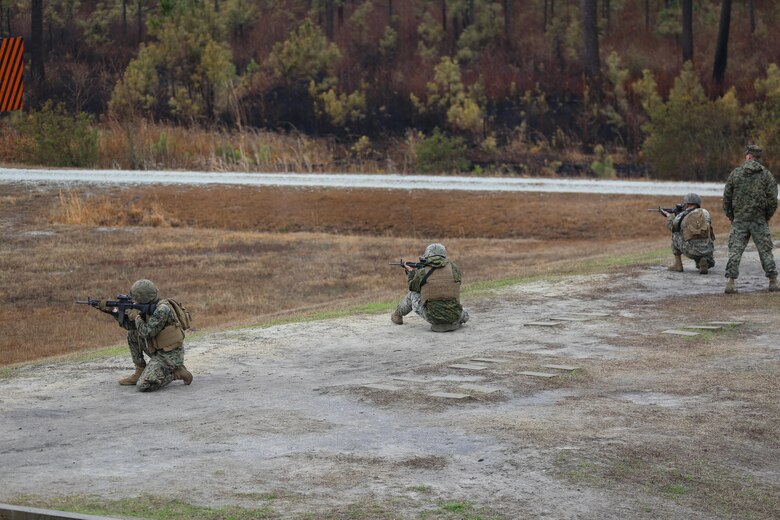 Marines with Transportation Support Company, Combat Logistics Battalion 2, firing from the kneeling position during a live fire exercise at Camp Lejeune, N.C., Feb. 3, 2017. The Marines conducted the training in order to familiarize themselves with their newly issued rifles in preparation for annual rifle qualifications. The Marines were able to get their Battle Sight Zero (BZO) to provide accurate and effective training as they continue on to other ranges in the coming months. (Marine Corps photo by Cpl. Shannon Kroening)