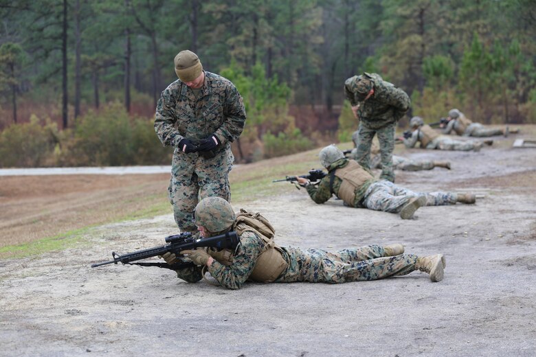 Marines with Transportation Support Company, Combat Logistics Battalion 2, are instructed on proper firing techniques during a live fire exercise at Camp Lejeune, N.C., Feb. 3, 2017. The Marines conducted the training in order to familiarize themselves with their newly issued rifles in preparation for annual rifle qualifications. The Marines were able to get their Battle Sight Zero (BZO) to provide accurate and effective training as they continue on to other ranges in the coming months. (Marine Corps photo by Cpl. Shannon Kroening)