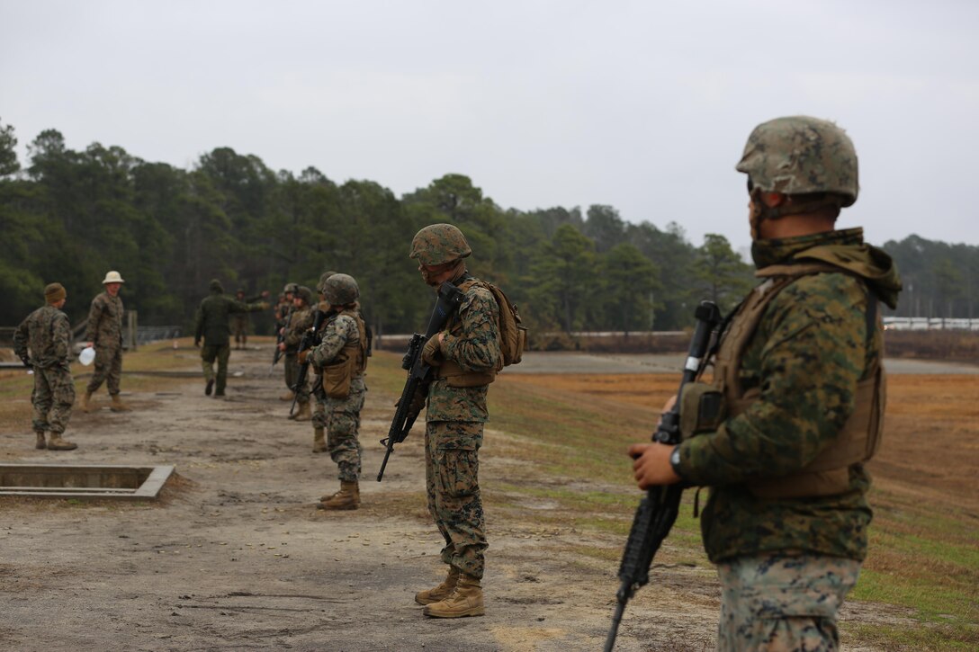 Marines with Transportation Support Company, Combat Logistics Battalion 2, wait for the command to face their targets and engage during a live fire exercise at Camp Lejeune, N.C., Feb. 3, 2017. The Marines conducted the training in order to familiarize themselves with their newly issued rifles in preparation for annual rifle qualifications. The Marines were able to get their Battle Sight Zero (BZO) to provide accurate and effective training as they continue on to other ranges in the coming months. (Marine Corps photo by Cpl. Shannon Kroening)