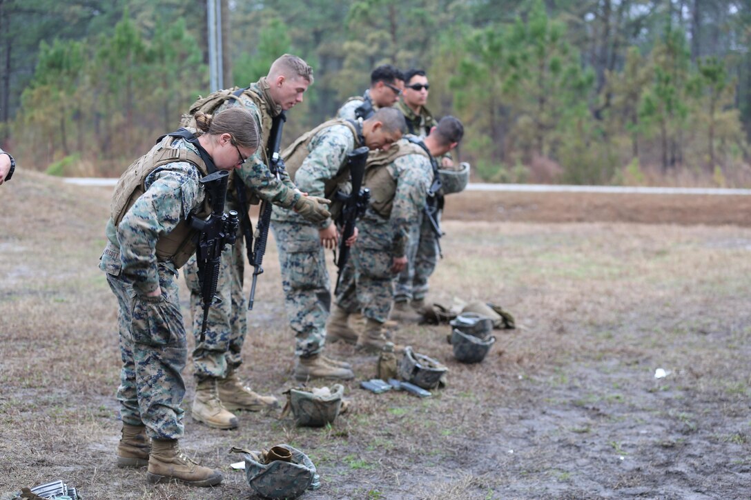 Marines with Transportation Support Company, Combat Logistics Battalion 2, prepare to be checked for extra rounds after a live fire exercise at Camp Lejeune, N.C., Feb. 3, 2017. The Marines conducted the training in order to familiarize themselves with their newly issued rifles in preparation for annual rifle qualifications. The Marines were able to get their Battle Sight Zero (BZO) to provide accurate and effective training as they continue on to other ranges in the coming months. (Marine Corps photo by Cpl. Shannon Kroening)