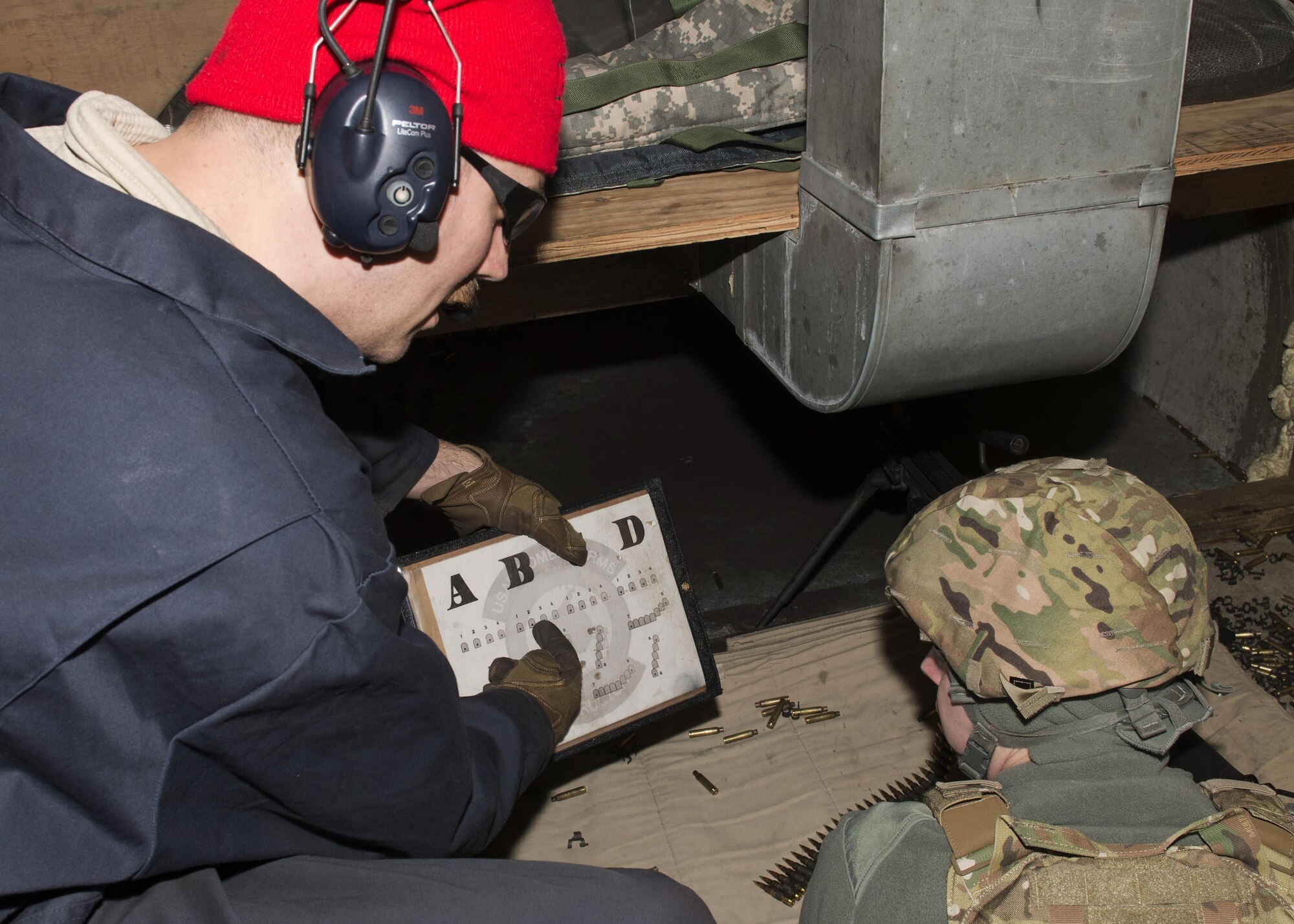 Staff Sgt. Aaron Weber, 5th Security Forces Squadron combat arms training and maintenance instructor, instructs a student at the CATM site on Minot Air Force Base, N.D., Feb. 1, 2017. CATM instructors are security forces personnel who train military members on how to properly use firearms. (U.S. Air Force photo/Airman 1st Class Alyssa M. Akers)