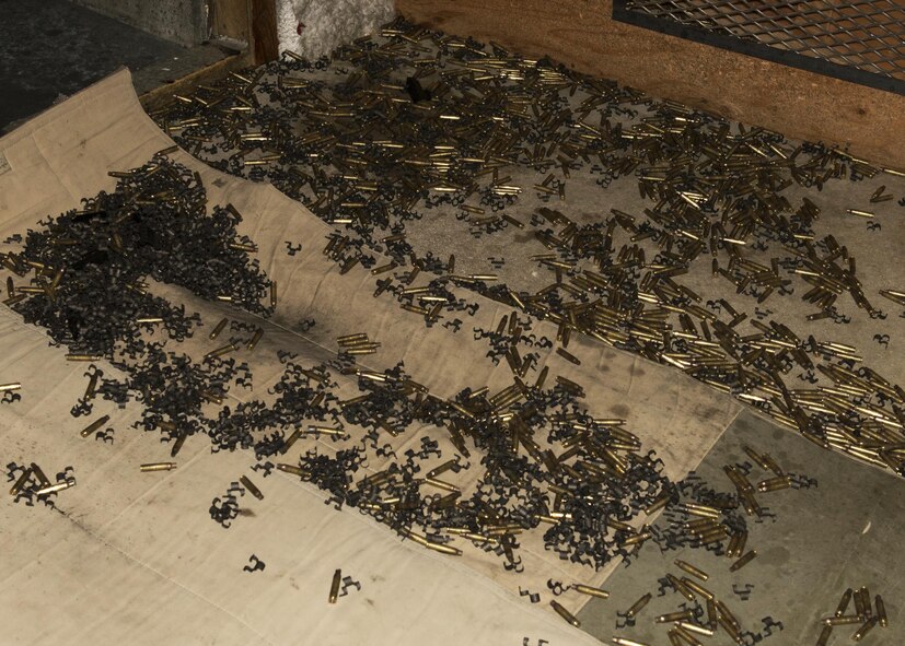 Empty cartridges litter the floor of the combat arms training and maintenance firing range on Minot Air Force Base, N.D., Feb. 1, 2017. The M249 light machine gun uses 5.56x45 mm NATO ammunition fired from a magazine. (U.S. Air Force photo/Airman 1st Class Alyssa M. Akers)