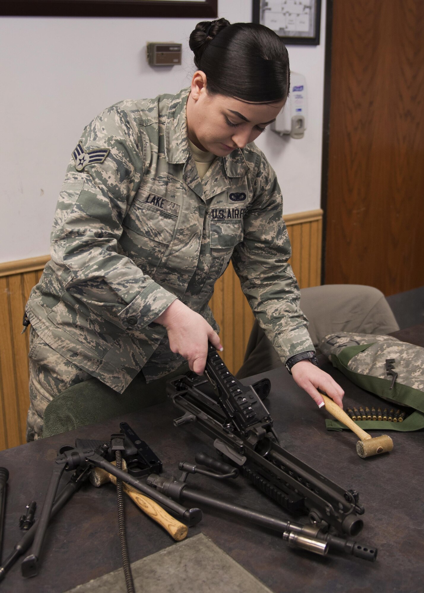 Senior Airman Bailey Lake, 5th Security Forces Squadron combat arms training and maintenance student, takes apart an M249 light machine gun at the CATM site on Minot Air Force Base, N.D., Feb. 1, 2017. To qualify on a firearm at CATM, every student must be able to break down and rebuild the firearm. (U.S. Air Force photo/Airman 1st Class Alyssa M. Akers)