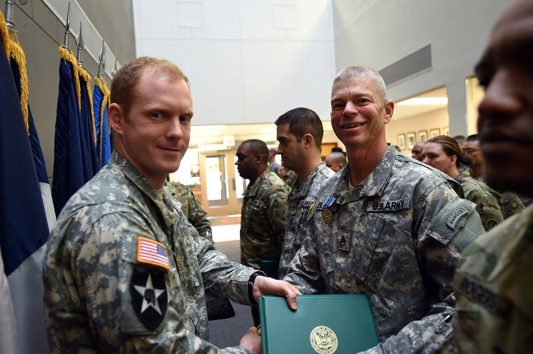 Staff Sgt. David Blegen, right, Chaplains Assistant, 85th Support Command, receives an Army Achievement Medal from Maj. Russell Litko, Headquarters and Headquarters Company Commander, for his achievements serving as a chaplain's assistant in the command's chaplain section, Jan. 8, 2017.
(Photo by Sgt. Aaron Berogan)