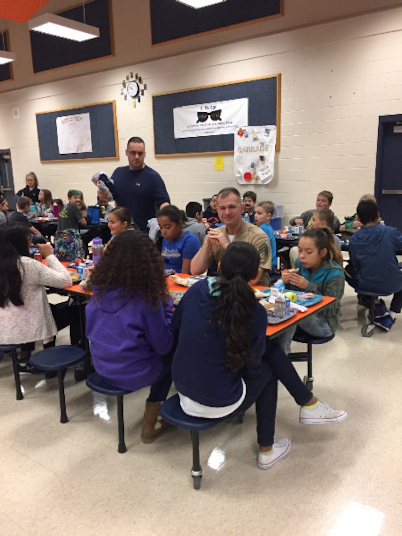 Marines help with the Lunch Buddy Program at Shirley Heim Middle School