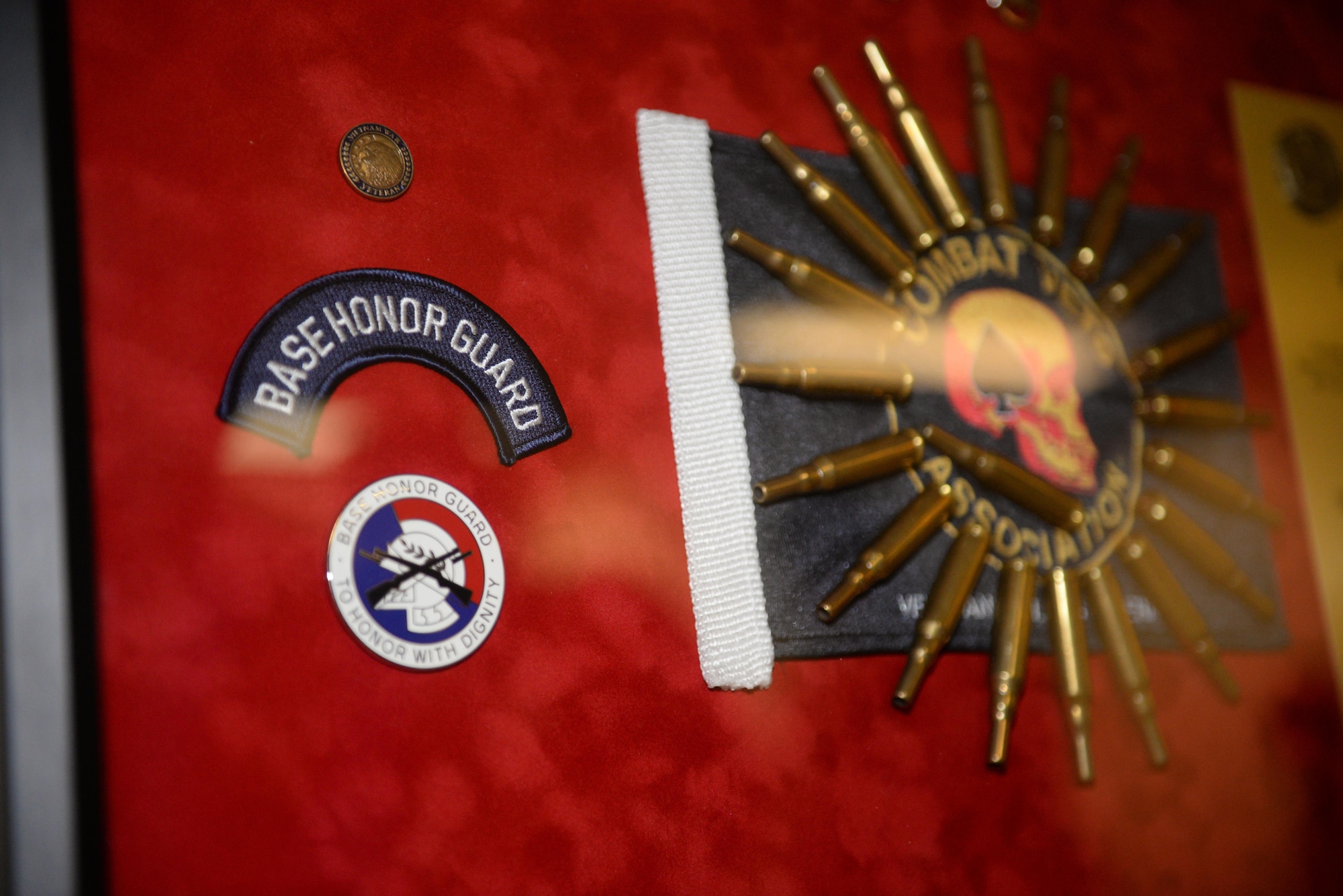 A shadow box sits on display during a presentation ceremony at the Locker House Jan. 26, 2017 on Keesler Air Force Base, Miss. During the ceremony, the Combat Veteran Motorcycle Association presented a shadow box to the Keesler AFB Honor Guard for their roll in five Congressional Medal of Honor ceremonies and numerous funerals held at the Biloxi National Cemetery during the last six years. (U.S. Air Force photo by Airman 1st Class Travis Beihl)