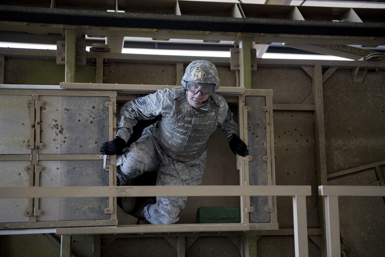 Tech. Sgt. Russell Cihal, 563d Rescue Group command, control, communications, computers and intelligence flight chief, climbs out of a mine-resistant, ambush-protected (MRAP) vehicle roll-over simulator, Feb. 3, 2017, at Moody Air Force Base, Ga. The roll-over simulators have the capabilities to spin 360 degrees. (U.S. Air Force photo by Airman 1st Class Daniel Snider)