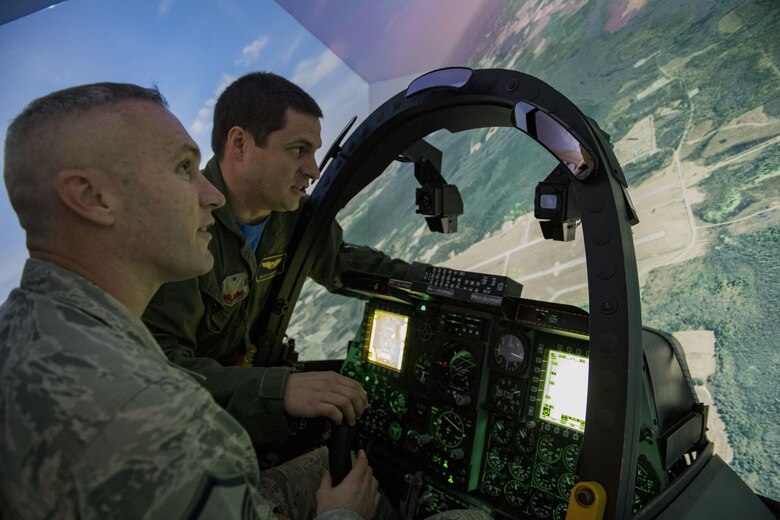 Master Sgt. Jason Bradley, 23d Medical Operations Squadron superintendent, works the controls in the A-10C Thunderbolt II flight simulator, Feb. 3, 2017, at Moody Air Force Base, Ga. Airmen were coached throughout the flight by actual A-10 pilots. (U.S. Air Force photo by Airman 1st Class Daniel Snider)