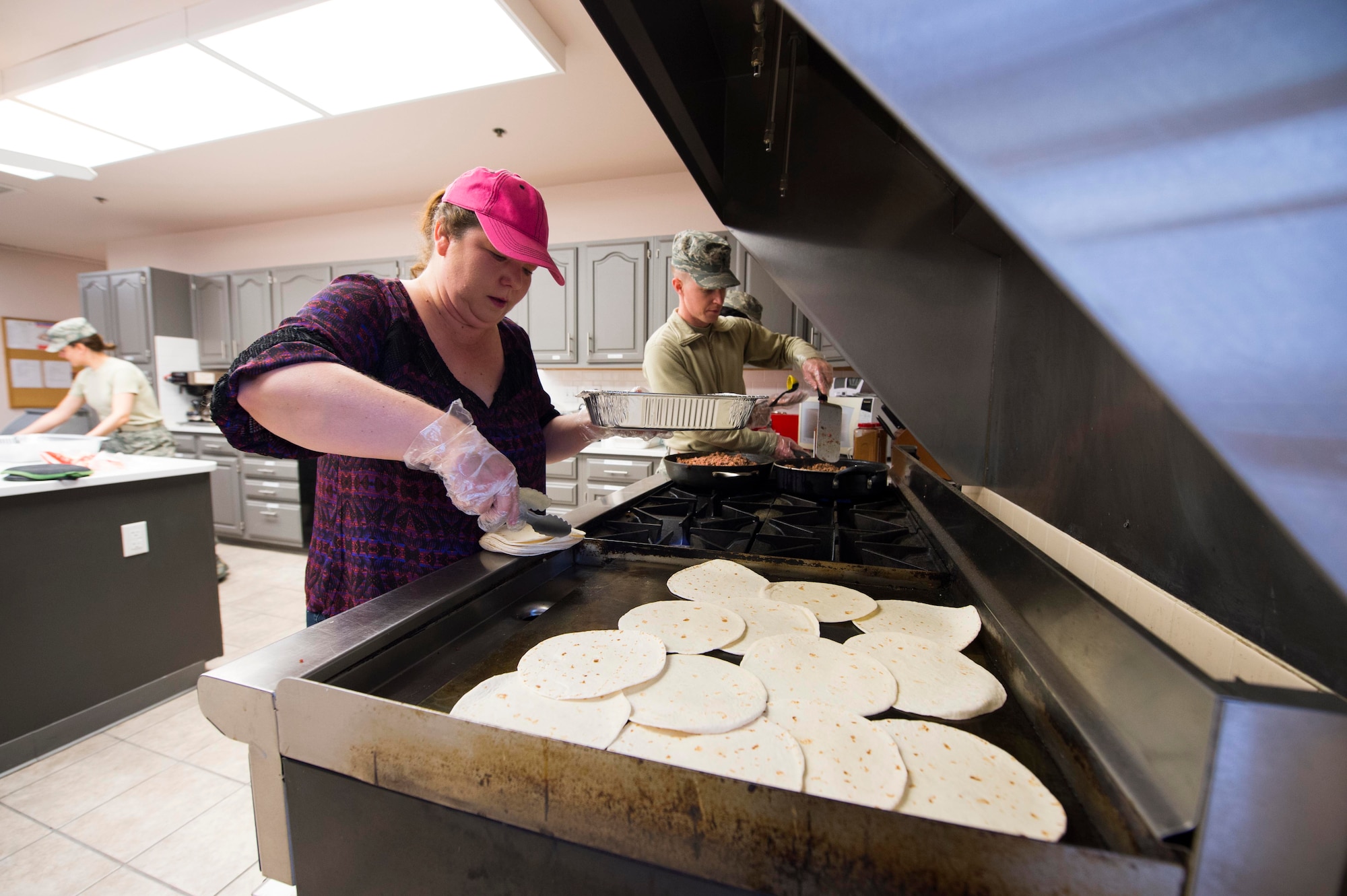 Rhonda Coburn, fellowship luncheon volunteer, prepares tortillas on a stove in the Chapel Activity Center at F.E. Warren Air Force Base, Wyo., Feb. 2, 2017. The 90th Missile Wing Chaplain Corps hosts a monthly fellowship luncheon for all base personnel. (U.S. Air Force photo by Staff Sgt. Christopher Ruano)