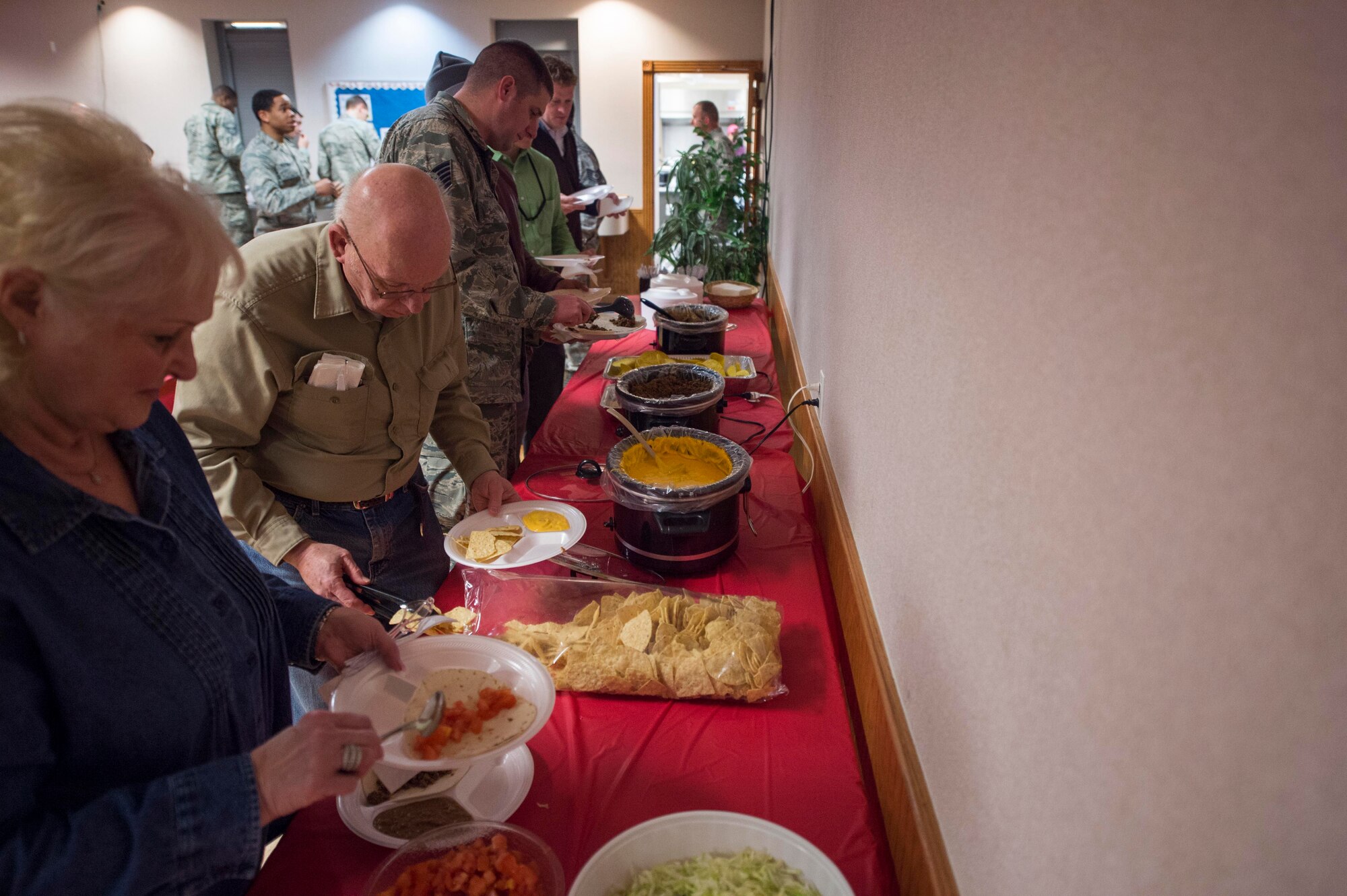 Members of the base community gather food on their plates during the fellowship luncheon in the Chapel Activity Center at F.E. Warren Air Force Base, Wyo., Feb. 2, 2017. The fellowship luncheons give people a chance to sit down, talk to one another and enjoy social bonding while eating lunch. (U.S. Air Force photo by Terry Higgins)