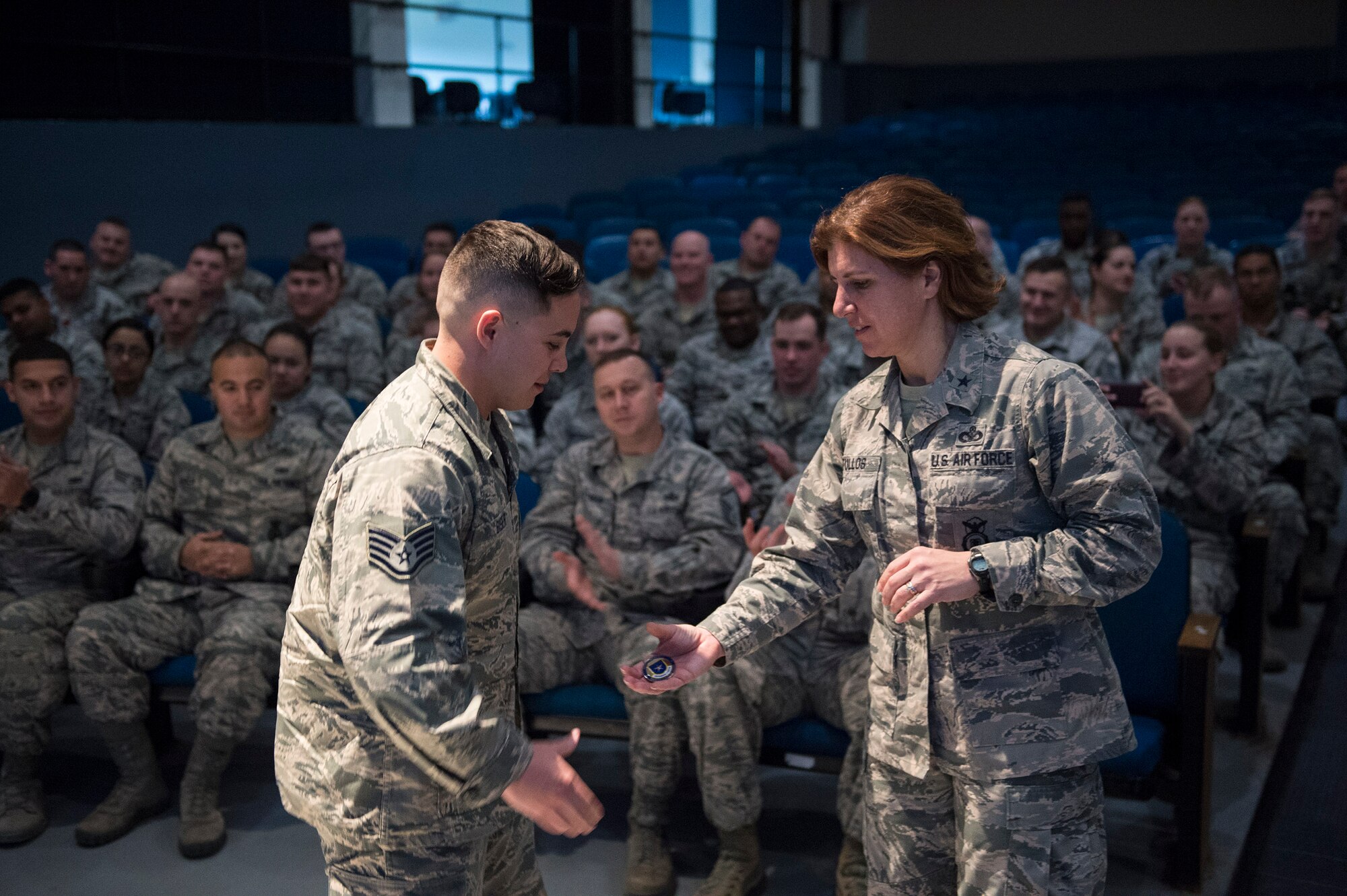 Staff Sgt. Max Biser, 23d Security Forces Squadron NCO in charge of confinement, accepts a coin from Brig. Gen. Andrea Tullos, Air Force director of security forces, Feb. 1, 2017, at Moody Air Force Base, Ga. Tullos recognized multiple Airmen from the 23d SFS and 820th Base Defense Group for being stellar in executing the mission. (U.S. Air Force photo by Airman 1st Class Greg Nash)