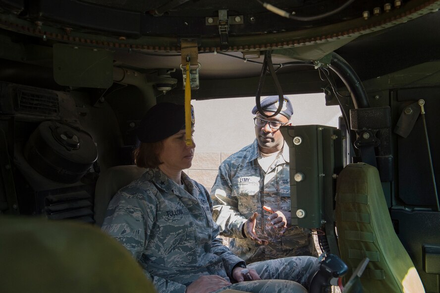 Staff Sgt. Patrick Lemy, 820th Combat Operations Squadron NCO in charge of small unmanned aerial systems, talks to Brig. Gen. Andrea Tullos, Air Force director of security forces, about the capabilities of the common remotely operated weapon station (CROWS) in a Humvee, Feb. 1, 2017, at Moody Air Force Base, Ga. Lemy expressed the importance of the rare opportunity to have a “Top Cop” visit Moody and the chance to gain an in-depth view of where the security forces career field is headed. (U.S. Air Force photo by Airman 1st Class Greg Nash)