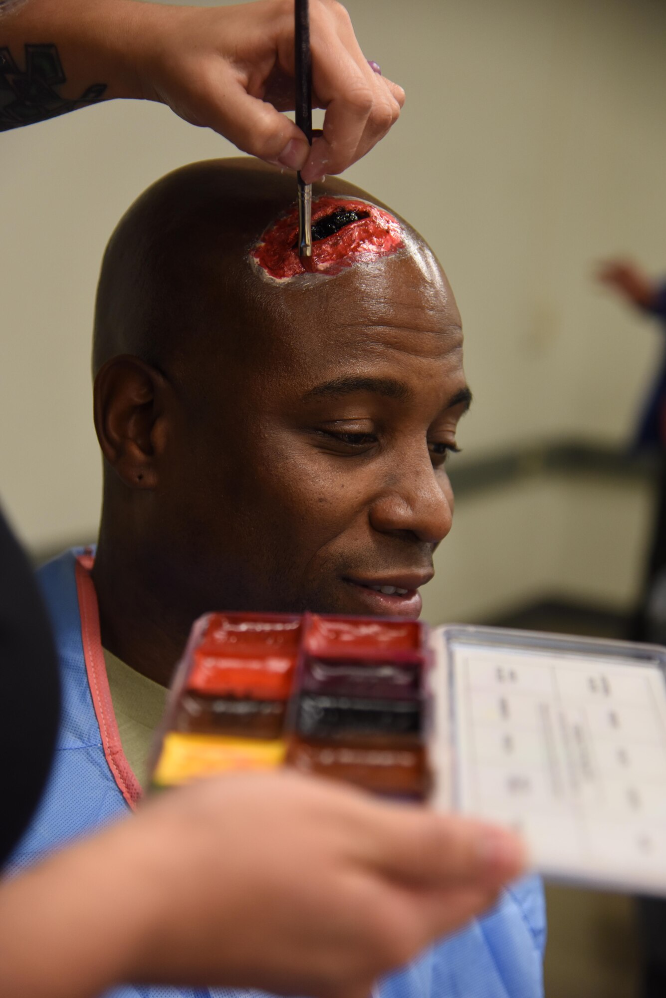 Master Sgt. Al Jervier, 335th Training Squadron flight chief, has moulage applied to his head during a moulage training session at Allee Hall Jan. 18, 2017, on Keesler Air Force Base, Miss. The session was held to teach volunteers how to apply moulage on exercise “casualties” to provide emergency responders with a more realistic training experience. (U.S. Air Force photo by Kemberly Groue)