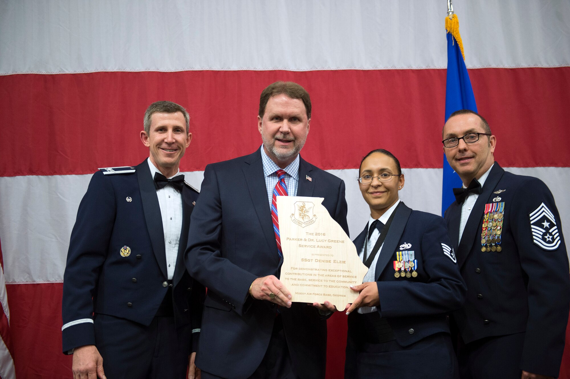 Staff Sgt. Denise Elzie, 23d Maintenance Group, receives the Dr. Lucy and Parker Greene Award during the 2016 Annual Awards Ceremony, Feb. 3, 2017, at Moody Air Force Base, Ga. Airmen must represent the Air Force core values, be highly engaged within the local community and actively pursue a higher education to be a candidate for the award. (U.S. Air Force photo by Airman 1st Class Greg Nash)