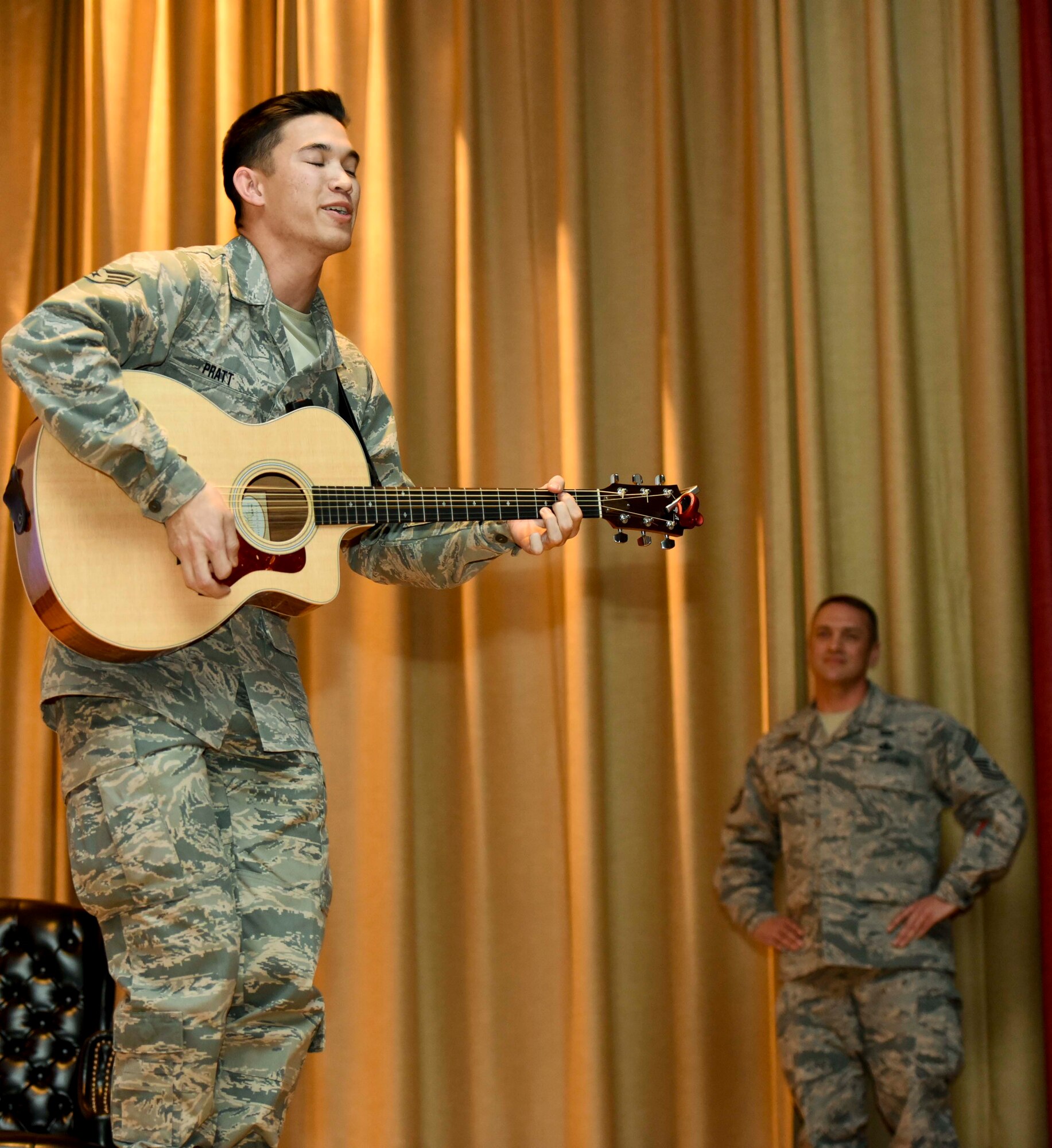 Senior Airman James Pratt, a heavy equipment operator assigned to the 28th Civil Engineer Squadron, performs John Mayer’s “Age of Worry” in front of the 28th Mission Support Group inside the base theater during their annual awards ceremony, Jan. 26, 2017, at Ellsworth Air Force Base, S.D. Pratt applied for the Air Force Entertainer of the Year by submitting a cell-phone video of himself performing a song. On Jan. 30, he was announced as the recipient of the Air Force-wide award and coined by Col. Gentry Boswell, the commander of the 28th Bomb Wing.  (U.S. Air Force photo by Airman 1st Class Randahl J. Jenson)