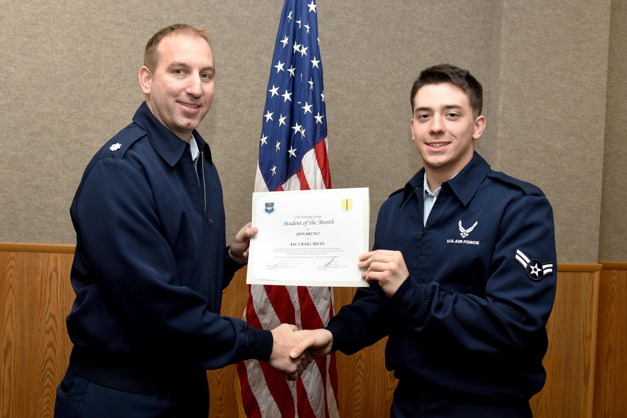 U.S. Air Force Lt. Col. Jason Kulchar, 315th Training Squadron director of operations, presents the 315th Training Squadron Student of the Month award for January 2017 to Airman 1st Class Craig Irvin, 315th TRS student, in the Brandenburg Hall on Goodfellow Air Force Base, Texas, Feb. 3, 2017. (U.S. Air Force photo by Staff Sgt. Joshua Edwards/Released)