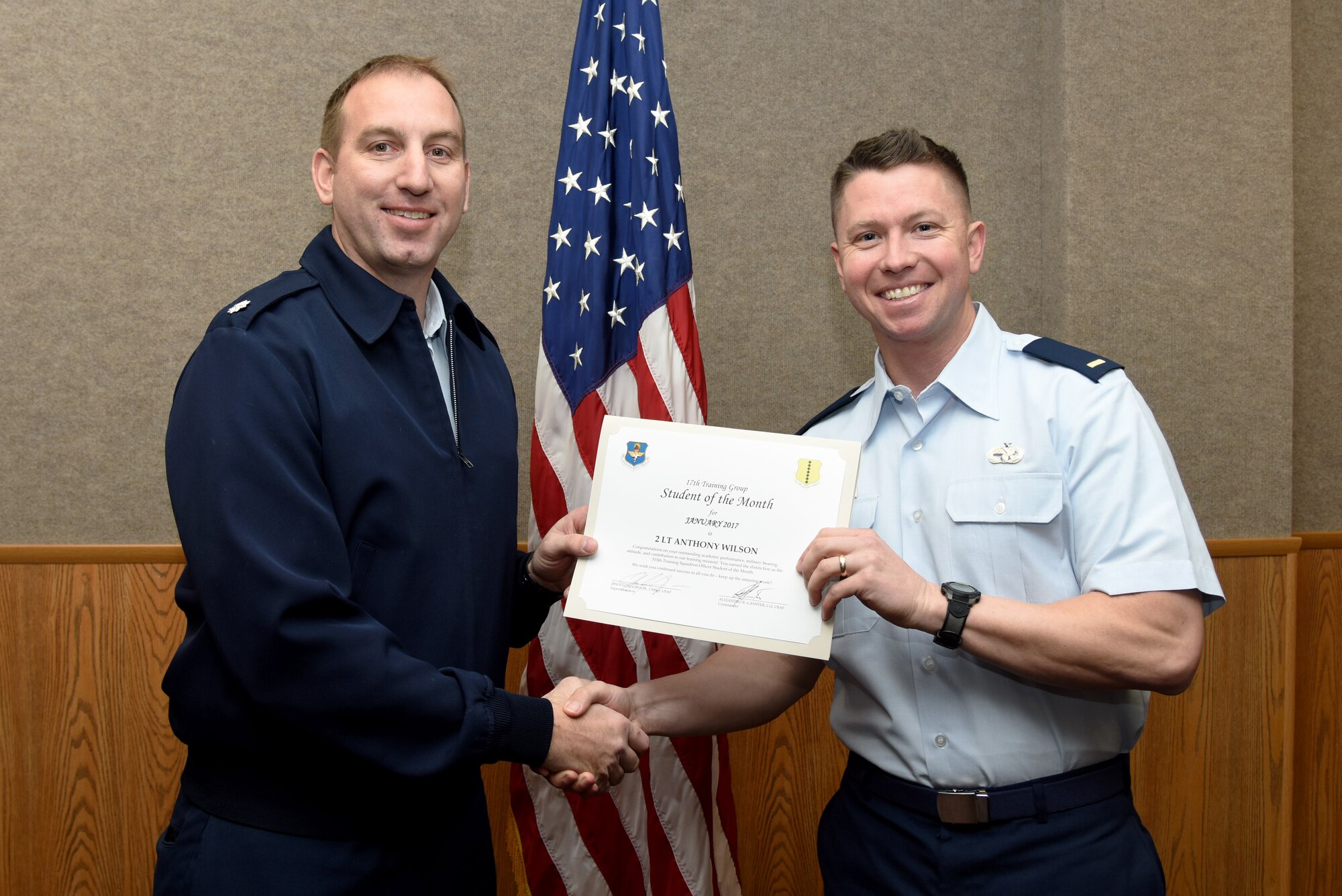 U.S. Air Force Lt. Col. Jason Kulchar, 315th Training Squadron director of operations, presents the 315th Officer Training Squadron Student of the Month award for January 2017 to 2nd Lt. Anthony Wilson, 315th TRS student, in the Brandenburg Hall on Goodfellow Air Force Base, Texas, Feb. 3, 2017. (U.S. Air Force photo by Staff Sgt. Joshua Edwards/Released)