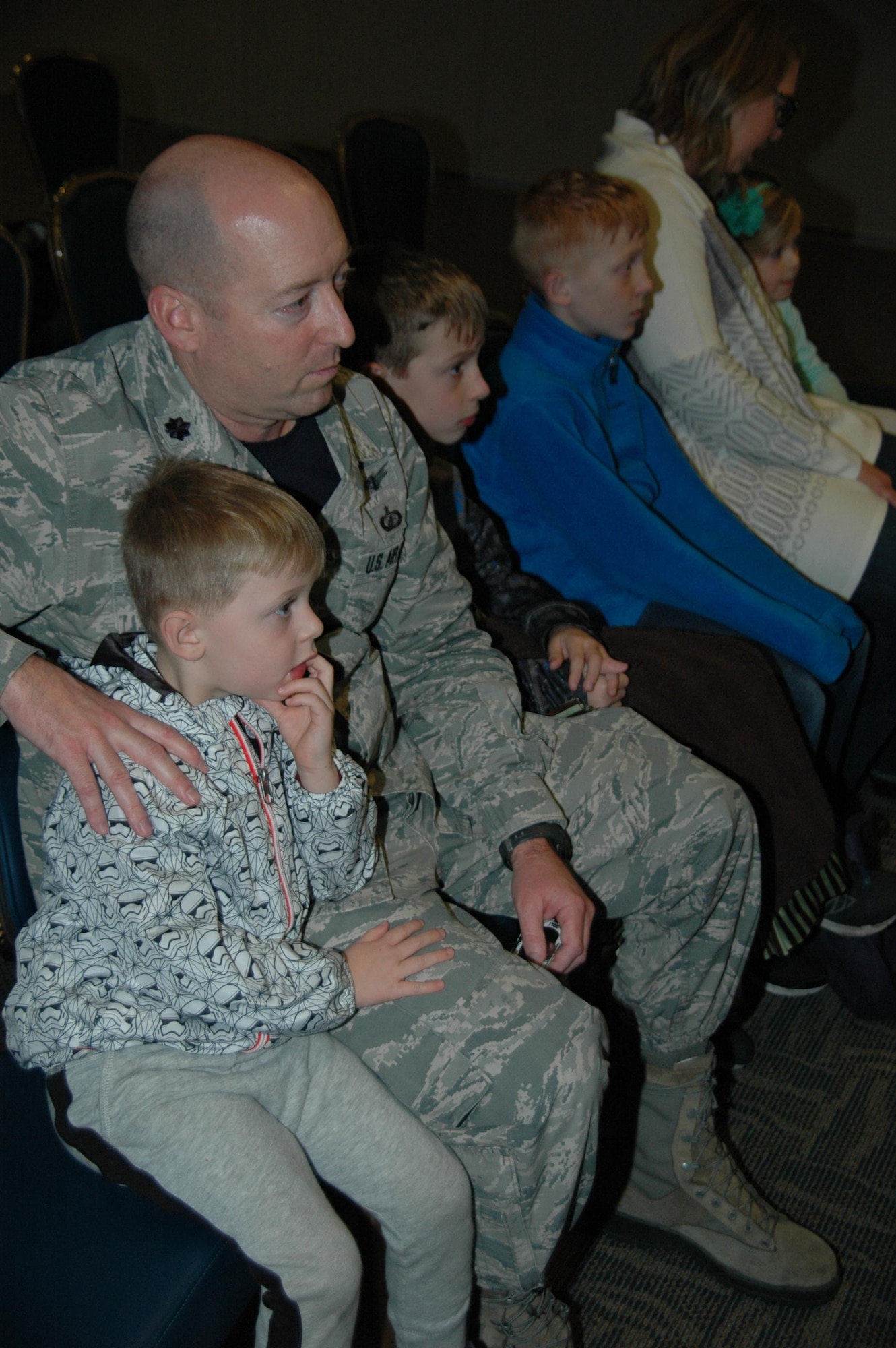 Lt. Col. John Mizell, materiel leader, SBIRS block development at the Space and Missile Systems Center, watches the launch proceedings of the third Space Based Infrared Systems Geosynchronous Earth Orbiting satellite with sons Eli, Paden, Luke, wife Kristen and daughter Adelyn during an SMC Presents “Launch and Learn” session in the Gordon Conference Center at Los Angeles Air Force Base in El Segundo, California. (U.S. Air Force photo/Jim Spellman)
 
