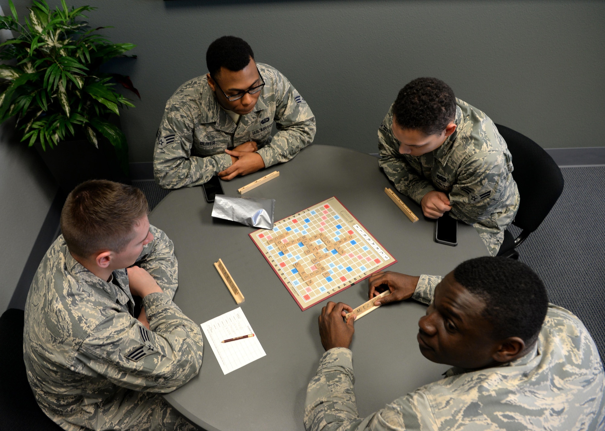 Airmen participate in a game of scrabble at the California CAfé at the Beale Community Activity Center, Feb. 3, 2017, at Beale Air Force Base, California. The CAFé lounge also offers free coffee, Wi-Fi, and a full surround sound projection screen. (U.S. Air Force photo/ Staff Sgt. Bobby Cummings)
