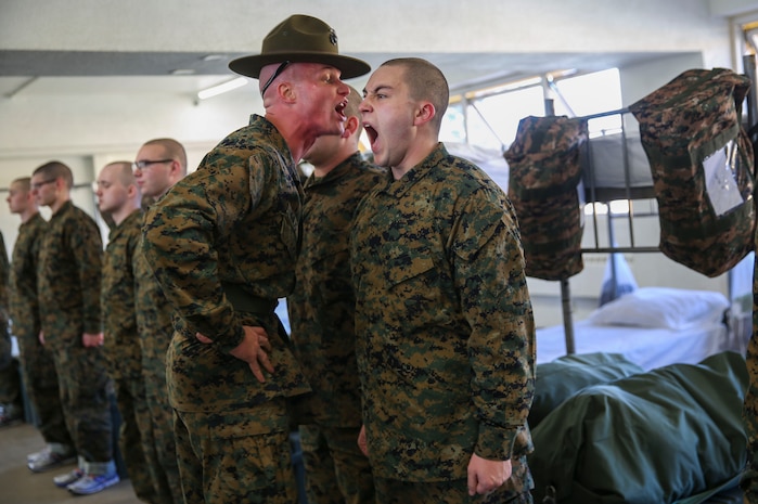 A drill instructor with Kilo Company, 3rd Recruit Training Battalion, instructs a recruit to respond louder during pick up at Marine Corps Recruit Depot San Diego, Jan. 27. The recruits will spend pick up with their drill instructors learning the rules and regulations of recruit training, regarding everything from how to act in the squad bay to how to speak to drill instructors. Annually, more than 17,000 males recruited from the Western Recruiting Region are trained at MCRD San Diego. Kilo Company is scheduled to graduate April 21.