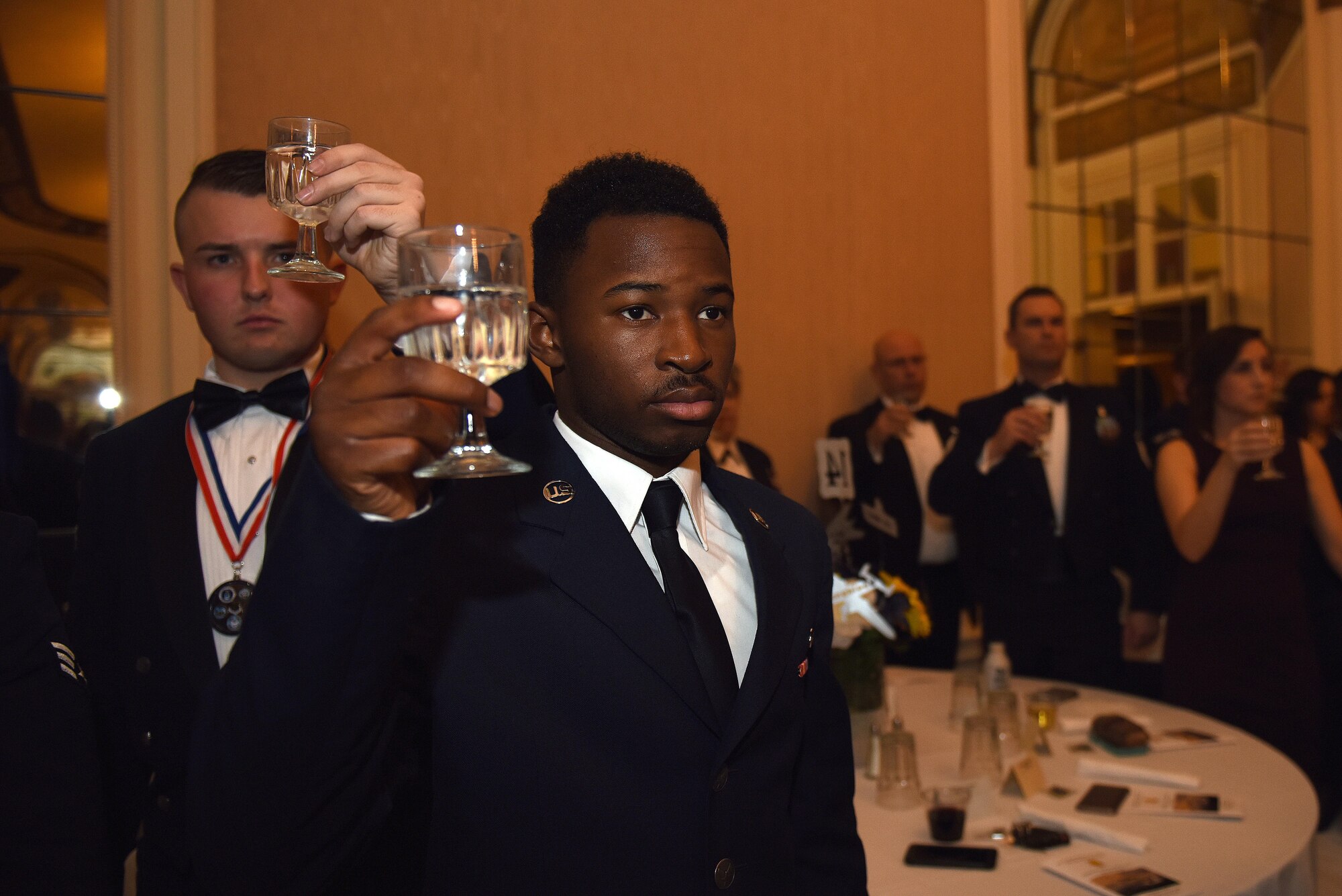 Goodfellow members raise their glass in honor of fallen service members during the Annual Awards Banquet at the Cactus Hotel in San Angelo, Texas, Feb. 3, 2017. Annual Award nominees wore their medallions and stood during the ceremony for special recognitions. (U.S. Air Force photo by Airman 1st Class Caelynn Ferguson/Released)