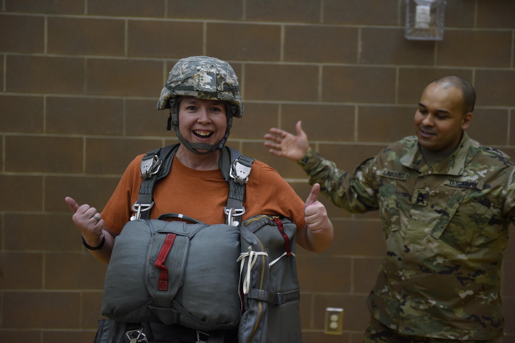 Jen Mickelson, Begich Middle School family school services support coordinator, poses for the camera after donning more than 100 pounds of equipment at Begich Middle School, Feb. 2, 2017. Headquarters and Headquarters Company, 4th Brigade Combat Team (Airborne), 25th Infantry Division Soldiers were one of many Science, Technology, Engineering, Art and Math presenters who interacted with about 300 students at the school's Career Fair. The fair is one of several annual events the unit's Soldiers support at the school as part of the Joint Base Elmendorf-Richardson School Partnership Program.