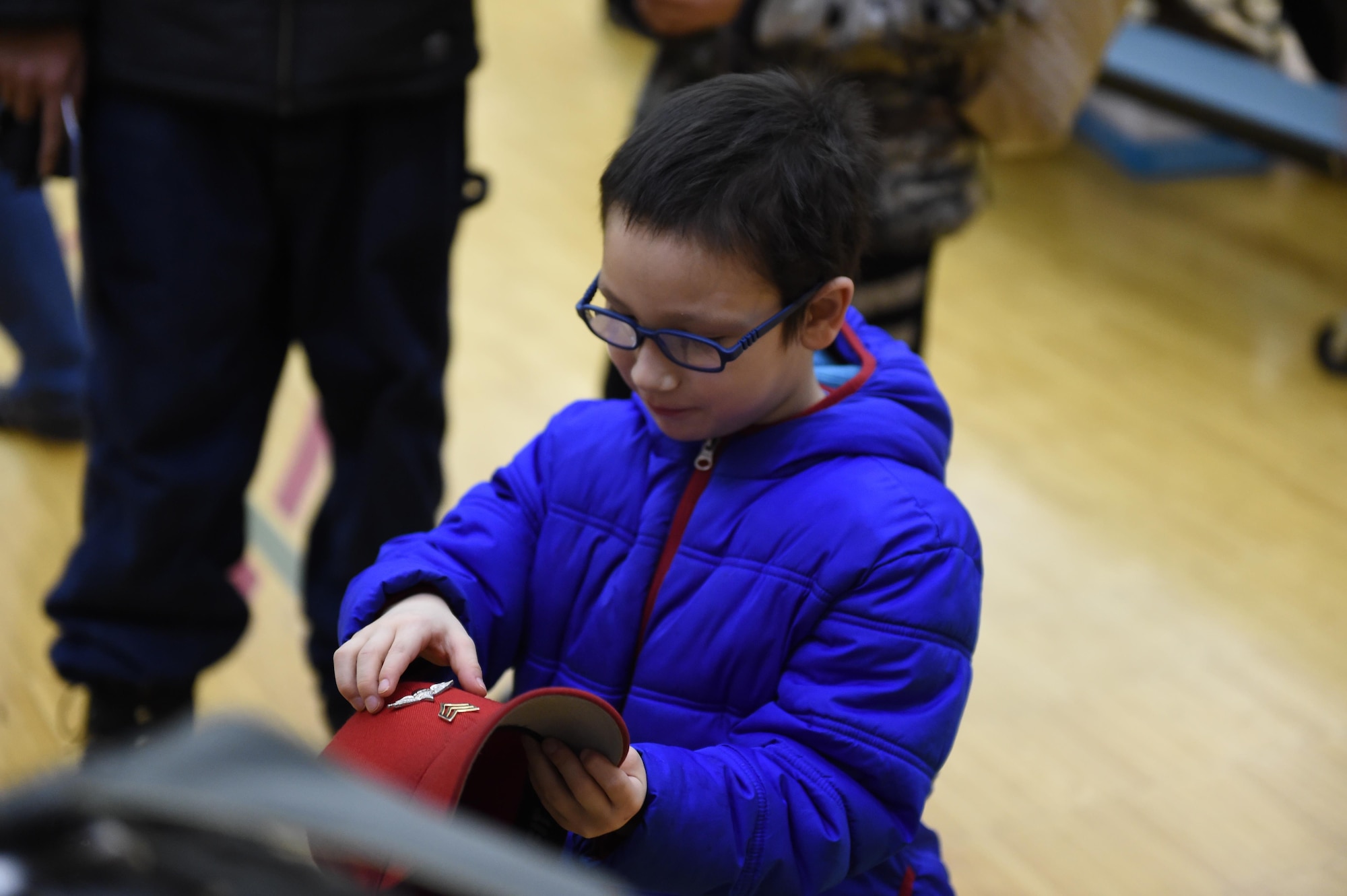 Brandon Wendt, 6, plays with a Soldier’s cap at Begich Middle School, Feb. 2, 2017. Headquarters and Headquarters Company, 4th Brigade Combat Team (Airborne), 25th Infantry Division Soldiers were one of many Science, Technology, Engineering, Art and Math presenters who interacted with about 300 students at the school's Career Fair. The fair is one of several annual events the unit's Soldiers support at the school as part of the Joint Base Elmendorf-Richardson School Partnership Program.