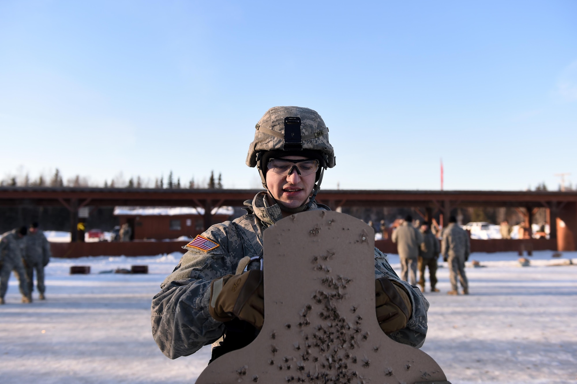Spc. Austin Day, 574th Composite Supply Company, 17th Combat Sustainment Support Battalion, U.S. Army Alaska vehicle mechanic, removes a firing target at the Sport Fire Range at Joint Base Elmendorf-Richardson, Alaska, Feb. 2, 2017.