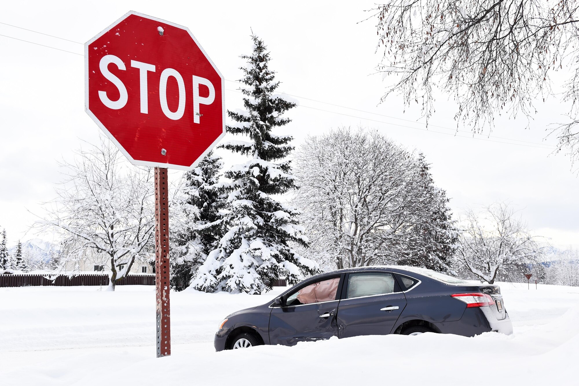 A car sits stranded on a Joint Base Elmendorf-Richardson road following an automobile accident, Jan. 24, 2017. Forty-seven car accidents were reported for Dec. 2016 – an increase from 17 reported in Dec. 2015. 