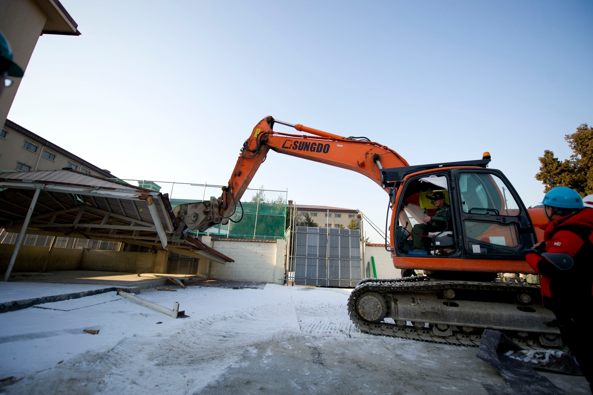 U.S. Air Force Col. Andrew Hansen, 51st Fighter Wing commander, uses an excavator to kick off the demolition of an old dorm at Osan Air Base, Republic of Korea, Feb. 1, 2017.  Dorm renovations on base started in the fall of 2016 and are scheduled to conclude in 2020.   (U.S. Air Force photo by Staff Sgt. Jonathan Steffen)