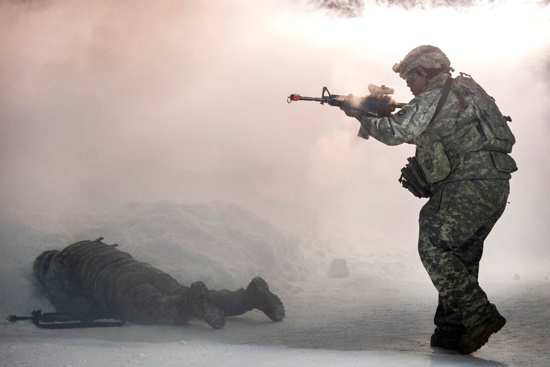 A soldier approaches a fallen team member responding to a simulated attack while participating in force protection sustainment training at Joint Base Elmendorf-Richardson, Alaska, Feb. 1, 2017. Air Force photo by Alejandro Pena 