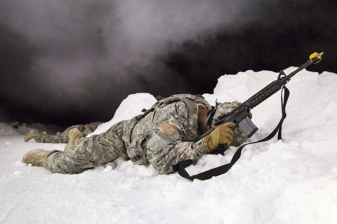 Army Pfc. Jalen Welch takes cover during a simulated indirect fire attack while participating in force protection sustainment training at Joint Base Elmendorf-Richardson, Alaska, Feb. 1, 2017. Welch is assigned to the 574th Composite Supply Company, 17th Combat Sustainment Support Battalion, Alaska. Air Force photo by Alejandro Pena