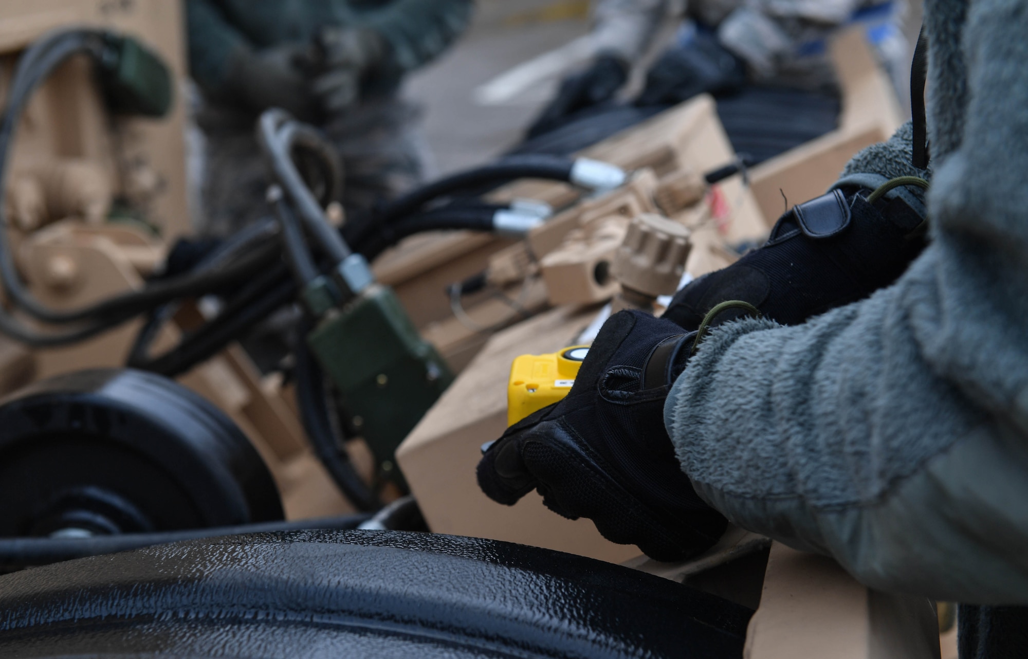 Tech. Sgt. Lashanda Lee, 435th Contingency Response Squadron NCO in charge of radio frequency transmission systems, operates hydraulics on a piece of equipment during Exercise Austere Forge on Ramstein Air Base, Germany, Jan. 31, 2017. Multiple pieces of equipment were used during the exercise to include 10K alternating forklifts, 25K loaders, all-terrain vehicles, tents, generators, and environment control units. The 435th Contingency Response Group participated in the exercise to practice their capability to deploy within 72 hours. (U.S. Air Force photo by Senior Airman Tryphena Mayhugh)