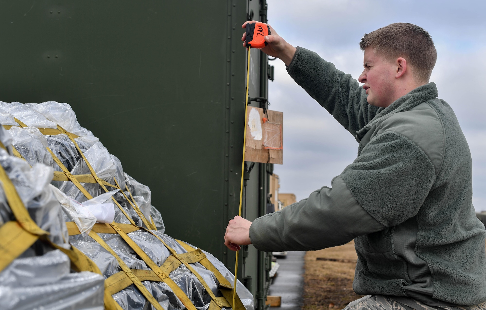 Airman Bryan McLaughlin, 86th Logistics Readiness deployment function air transportation specialist, measures the height of a pallet during the 435th Contingency Response Group’s Exercise Austere Forge at Ramstein Air Base, Germany, Jan. 31, 2017. The 435 CRG worked hand-in-hand with the 86 Logistics Readiness Squadron and the 86th Vehicle Readiness Squadron during the exercise. Airmen in the 435 CRG participated in the exercise to practice their capability to deploy within 72 hours. (U.S. Air Force photo by Senior Airman Tryphena Mayhugh)
