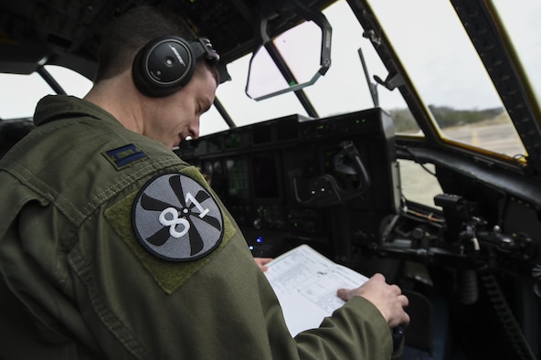 U.S. Air Force Capt. Kyle Gauthier, 61st Airlift Squadron C-130J pilot and flight commander, reviews a preflight checklist Feb. 3, 2017, at Little Rock Air Force Base, Ark. His shoulder patch indicates the C-130J Block 8.1 system upgrade and expansion. Gauthier, along with a team of 19th Airlift Wing Airmen, conducted Air Mobility Command’s first C-130J flight with the upgrade. (U.S. Air Force photo/Senior Airman Harry Brexel) 